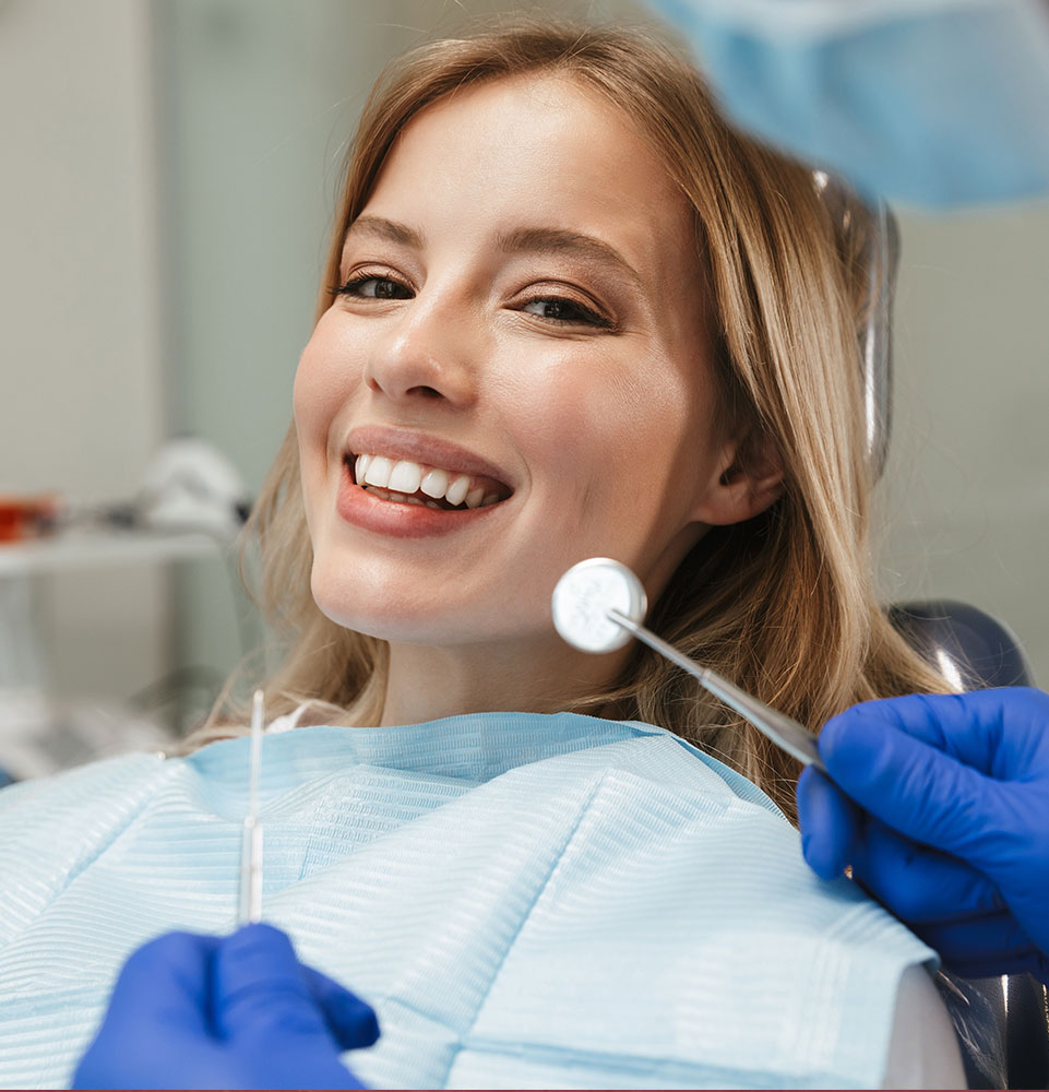 Image of beautiful woman sitting in dental chair while professional doctor fixing her teeth
