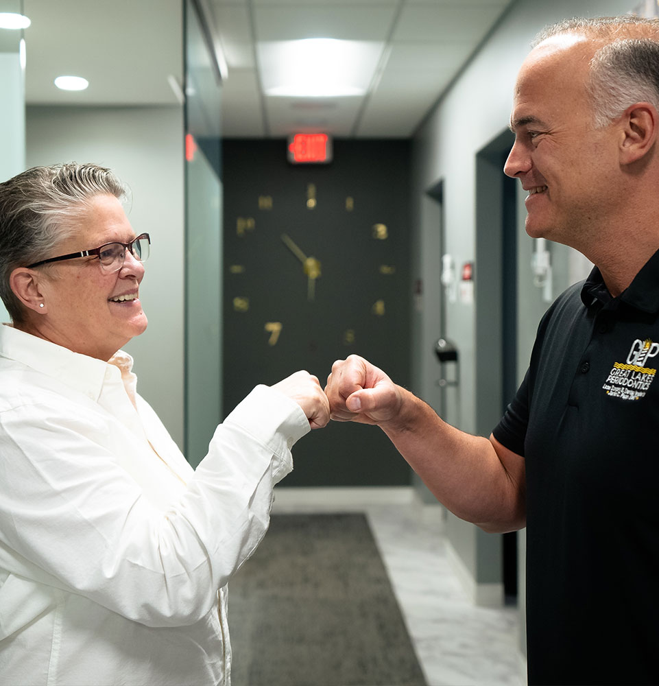 patient and doctor fist bumping and smiling in the dental center