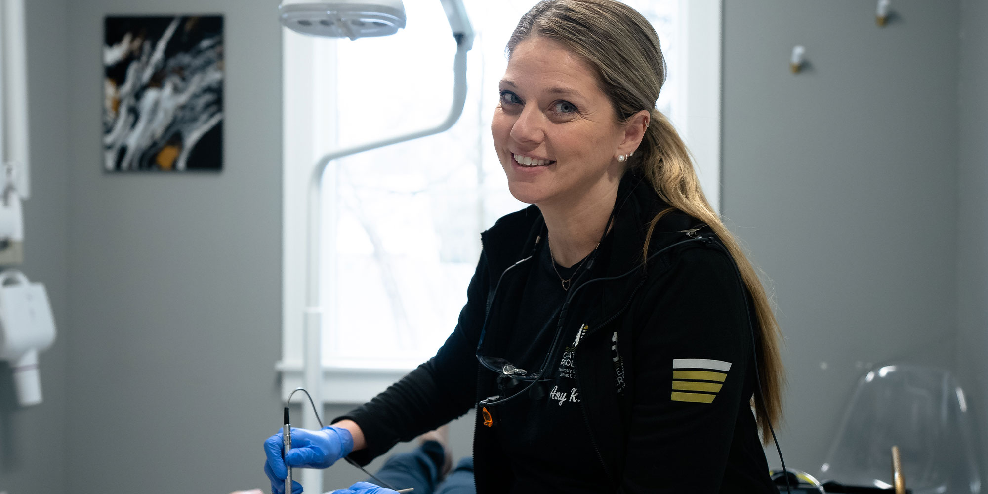 staff member performing dental examination within the dental operating room