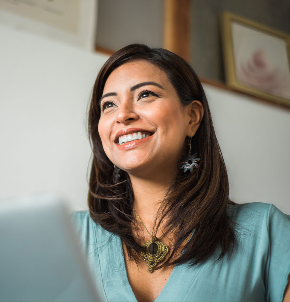 person using their laptop while smiling brightly