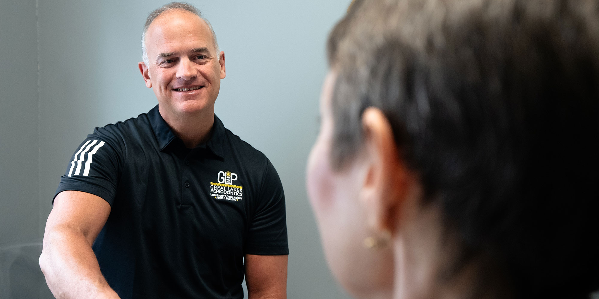 doctor shaking hands with patient and smiling brightly