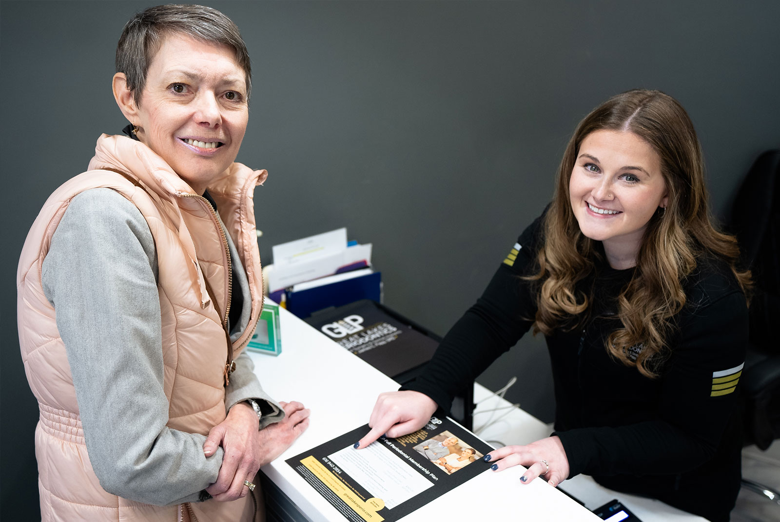 patient and staff member smiling while going over dental finance options