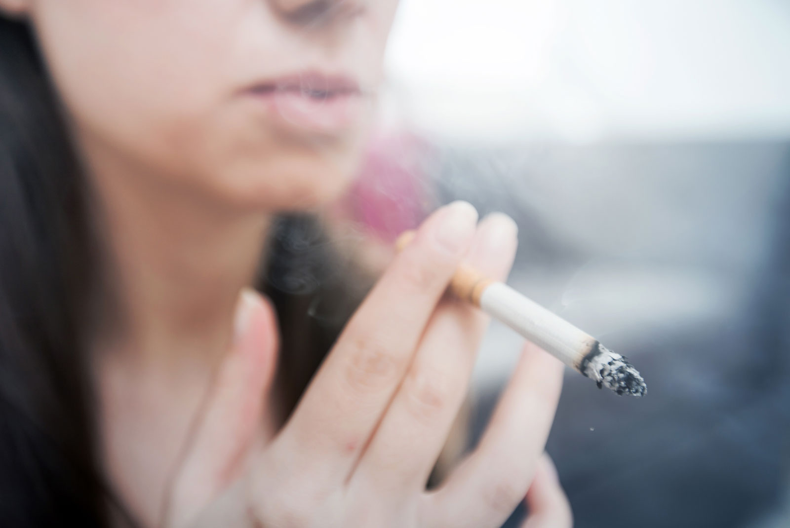 up close shot of person smoking a cigarette