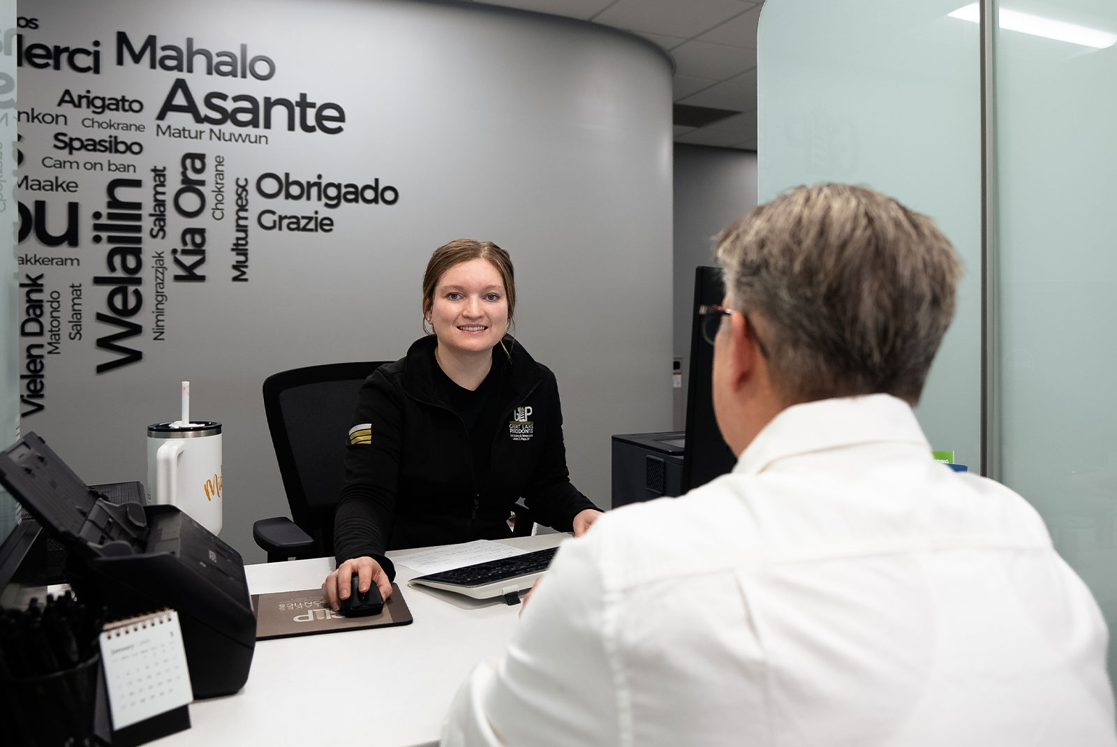 patient being helped at the front desk of the dental center with staff member